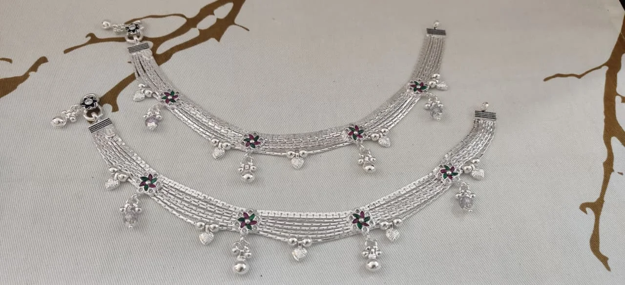 Multi-strand silver payal featuring colorful floral motifs, dangling ghungroos, and small ghungroo bells.