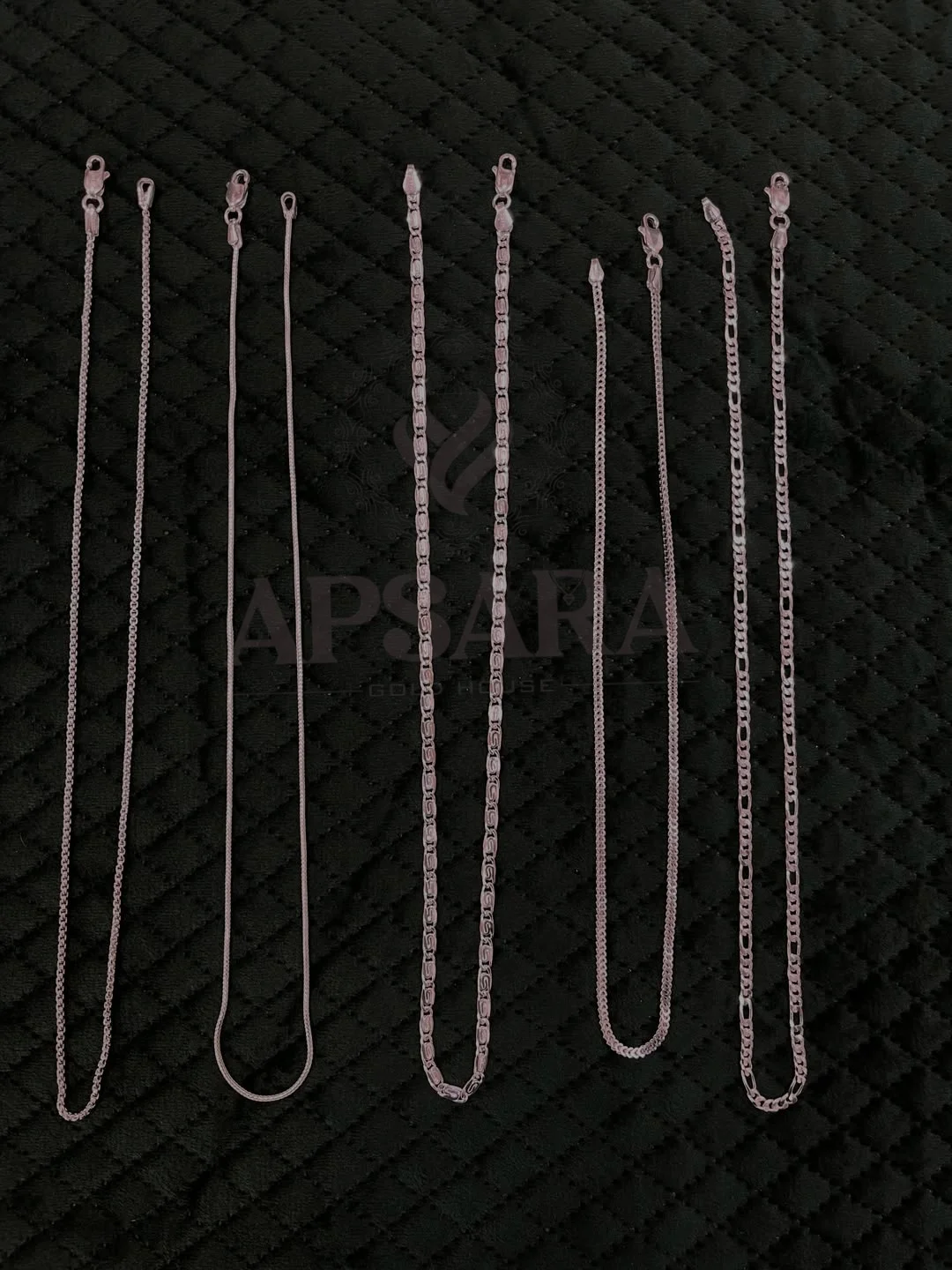 Plain silver chain with a polished finish, featuring multiple slim link designs arranged vertically.