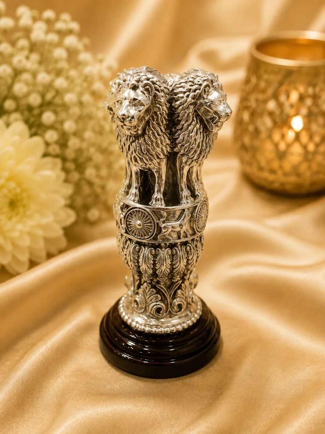 Detailed silver figurine of the national emblem featuring four lions standing back to back on an intricately carved circular base.
