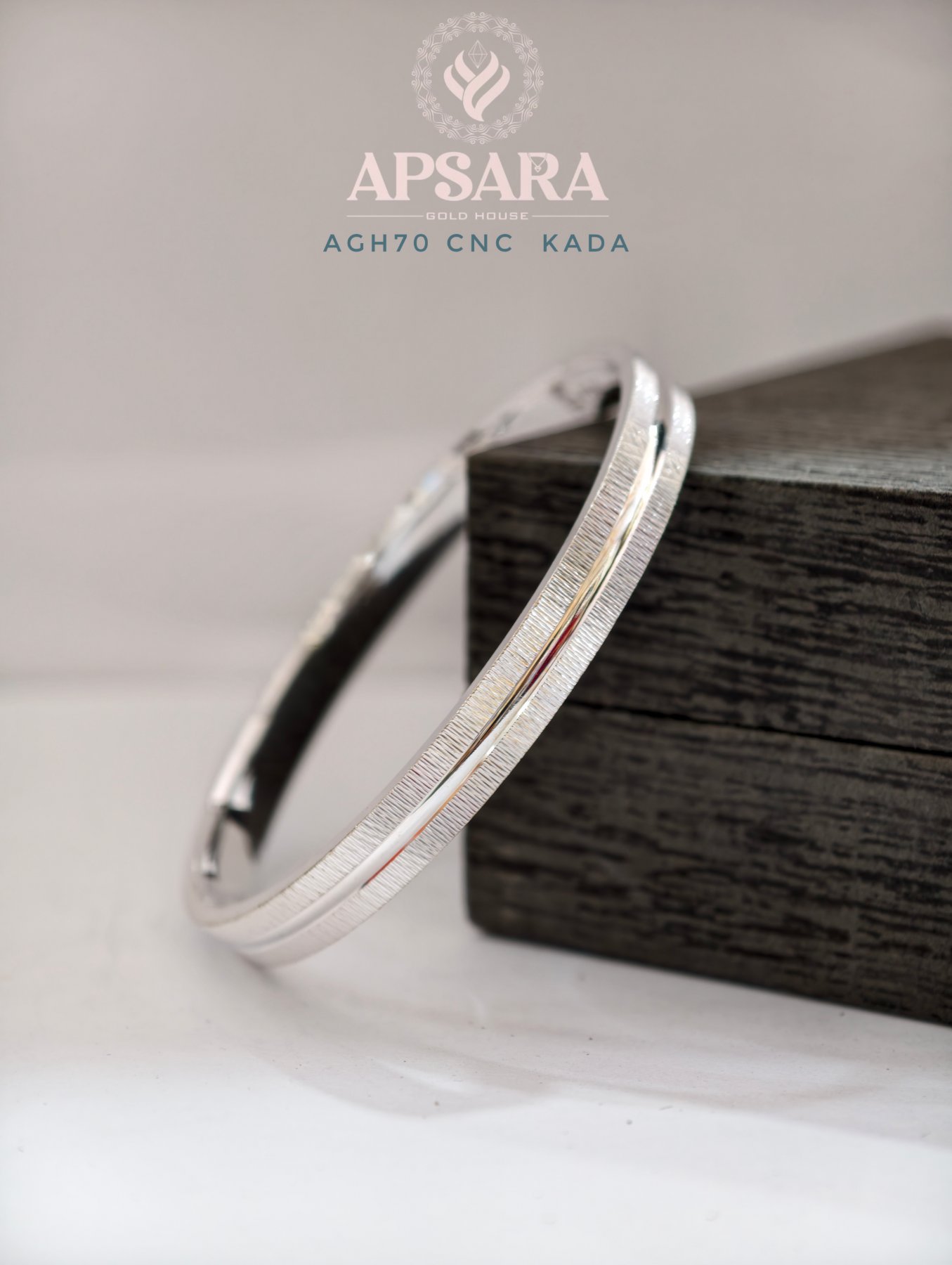 A flat silver kada with a shiny center line and textured matte finish on both sides.