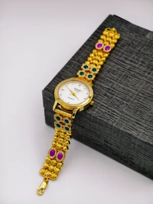 Gold polish silver watch with round dial, beaded strap, and pink and green stones.
