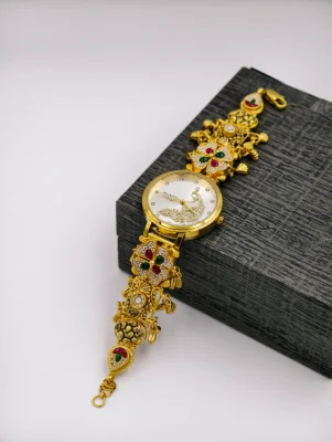 Gold polish silver watch with stone studded floral motifs and white dial.