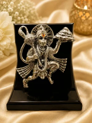 Oxidised silver plaque idol featuring Lord Hanuman carrying a mountain, with polished details and a red stone on the forehead.