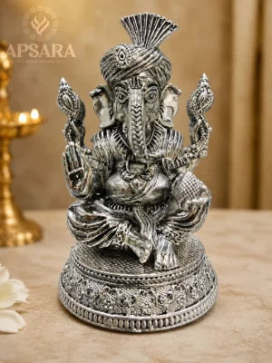 Detailed silver idol of Lord Ganesha featuring an oxidised finish and intricate traditional carvings.