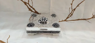 Square silver betel nut set featuring ornate floral motifs, intricate etched patterns, and an oxidised finish.