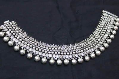Heavy oxidised silver payal featuring multiple rows of intricate bead patterns and hanging round ghungroos.
