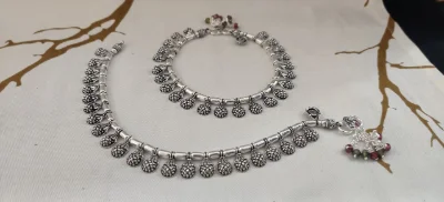 Oxidised silver payal featuring textured conical danglers and colourful bead charms.
