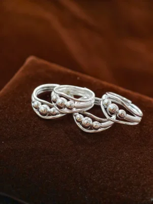Polished silver bichhiya featuring multiple glossy silver beads and delicate wire patterns.