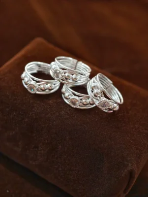 Silver bichhiya featuring multiple thin bands, shiny small beads, and a sparkling round stone in the center.