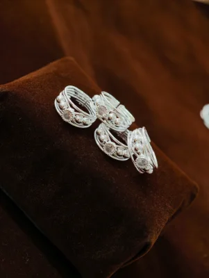 Set of multiple silver bichiya rings featuring a multi-layered design with bead accents and a central stone.
