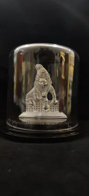 Solid silver idol with detailed carvings and glossy finish.