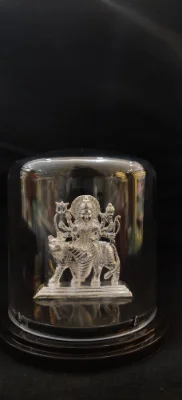Solid silver idol of goddess riding a tiger, featuring detailed carvings and a shiny finish.