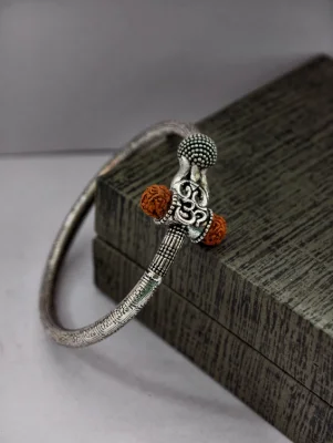 Oxidised silver kada featuring an om symbol and brown rudraksha beads.