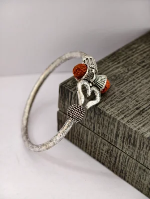 Oxidised silver kada features a Trishul design with brown rudraksha beads and textured finish.