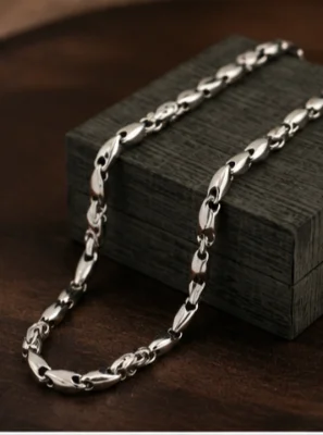 An oxidised silver chain featuring interlocking textured leaf-shaped links with a polished finish.