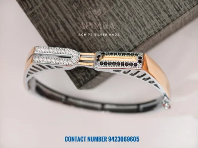 This silver fancy kada features white and black stones with dual polish.
