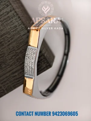 This silver kada features a dual tone polished surface with segments of white stone pave settings.