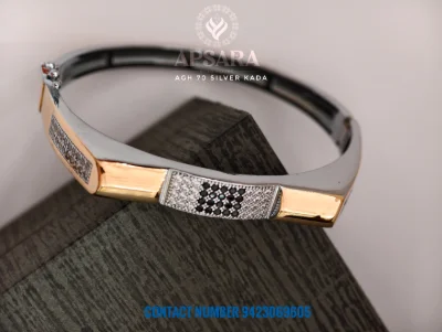 This silver fancy kada features geometric rose gold polish panels with white and black stone settings.