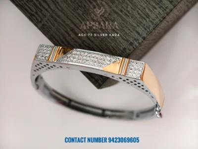 This fancy silver kada features sparkling white stones, textured patterns, and smooth polished sections in a modern rectangular design.