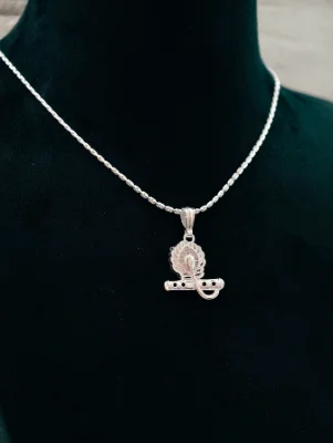 Silver chain featuring a detailed Lord Krishna locket shaped like a flute and peacock feather with sparkling stones.