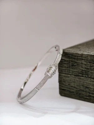 Silver stone kada bracelet featuring sparkling white stones in a sleek design.