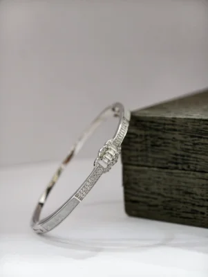 Silver stone kada bracelet featuring sparkling white stones and a glossy finish.