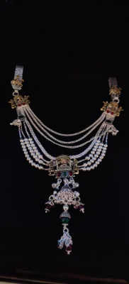 Oxidised silver half waist chain featuring multiple beaded and linked chains with dangling jhumkas and colourful stones.
