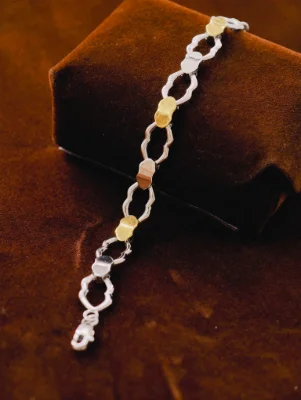 Silver Italian bracelet featuring interlocked patterned links with gold finish highlights.