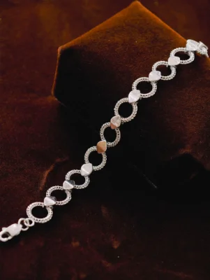 Silver Italian bracelet featuring alternating textured round links and smooth leaf-shaped metal elements.