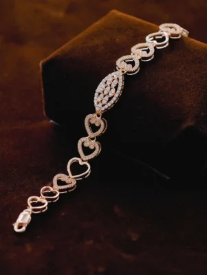 Silver Italian bracelet featuring interconnected heart links and a central marquise shaped motif studded with white stones.