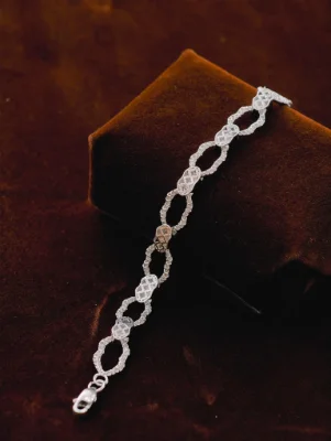 A silver Italian bracelet featuring interconnected oval links with textured patterns.