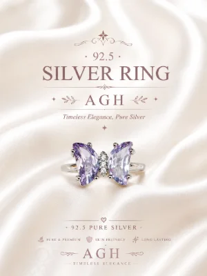 This butterfly shaped silver ring features two large purple stones and small white stones in the center.