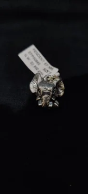Oxidised silver elephant face locket with detailed trunk and large ears, polished finish.