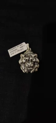 This silver locket features a detailed lion face design with an oxidised finish.