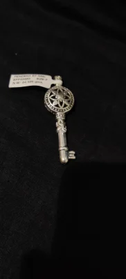 Oxidised silver key locket featuring intricate floral patterns and carved details.