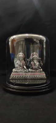 Oxidised silver silver heavy marti idol set featuring laxmi and ganesh adorned with red stones.