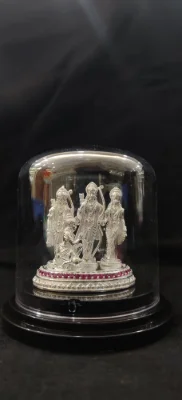 Heavy silver idol set depicting deities standing on a round base studded with red stones.