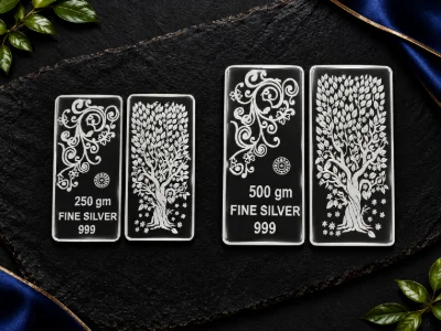 Rectangular silver bars feature an embossed floral scroll pattern and a detailed tree design with inscriptions.