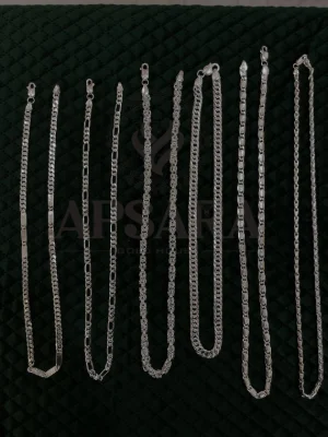 A collection of silver chains in various designs and links, featuring a polished silver finish.
