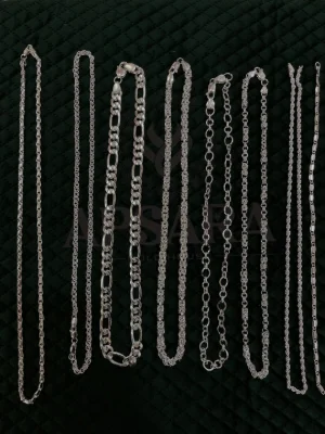 A variety of silver chains in different link designs and thicknesses featuring a polished metallic finish.