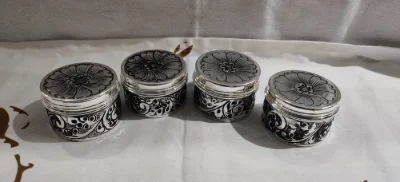 Round silver soap dish with engraved floral pattern and oxidised finish.