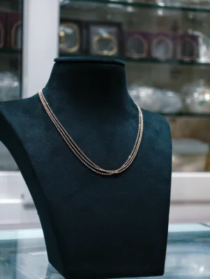 Three-strand silver beaded chain with a polished finish.