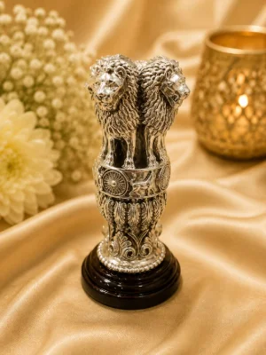 Detailed silver figurine of the national emblem featuring four lions standing back to back on an intricately carved circular base.