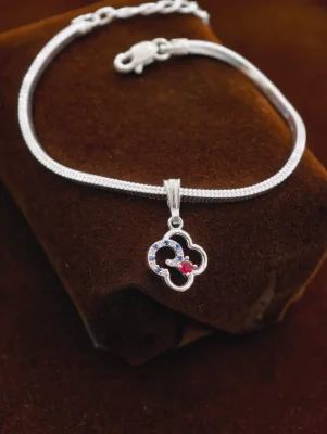 Silver chain bracelet featuring a flower pendant with blue and red stones.
