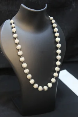 Sterling silver beaded necklace featuring textured round beads linked together.