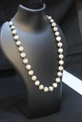 Sterling silver beaded necklace featuring textured round beads linked together.