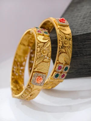 Gold polish silver kada set featuring intricate floral patterns, textured leaves, and colourful stone accents.